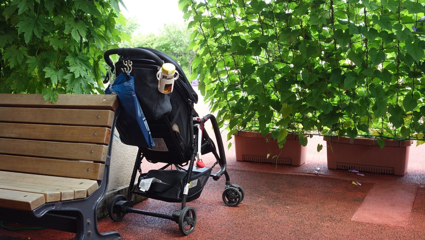 A baby stroller parked on a terrace.