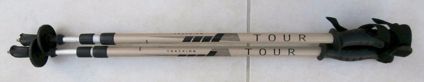 A pair of telescopic trekking poles, fully retracted.