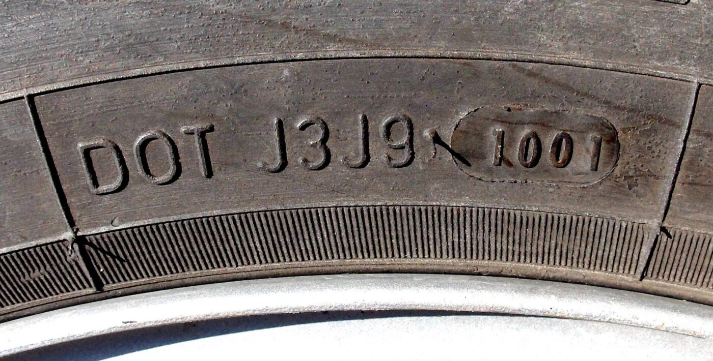 A close-up of a tyre sidewall showing the four-digit DOT date code.