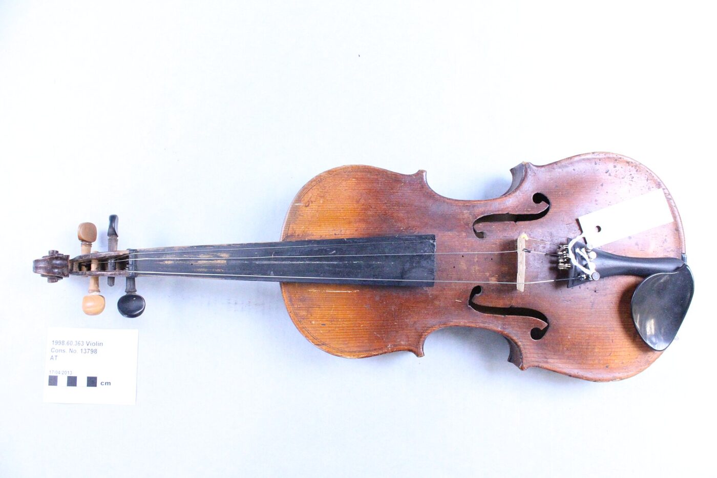 Studio photo of a complete violin and bow on a white background.