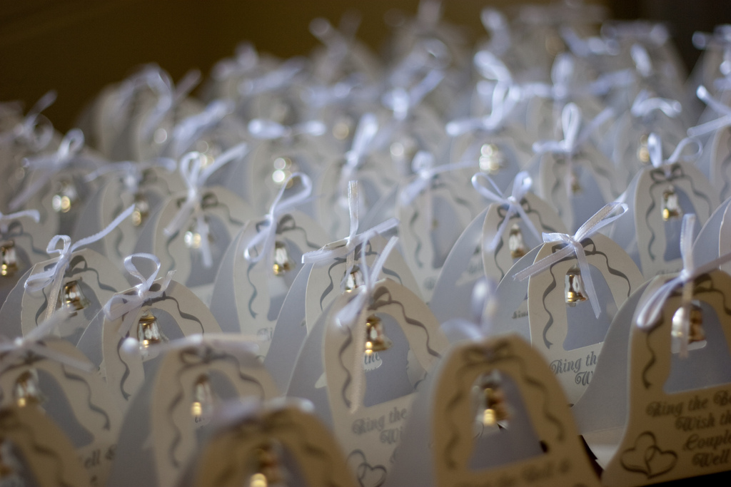Rows of small wrapped wedding favours.