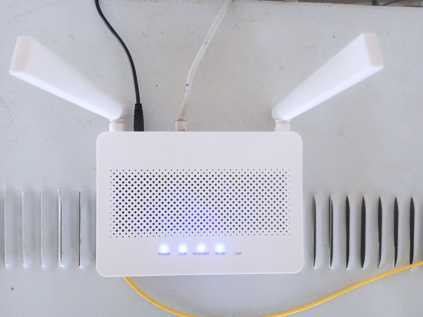 A home Wi-Fi router. Extenders repeat its signal; mesh nodes coordinate with it.