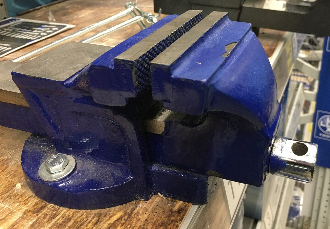 A bench vise on display in a hardware store.