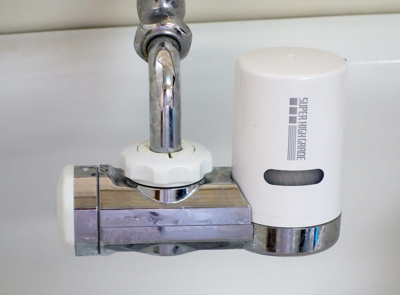 A water filter attached to a kitchen faucet