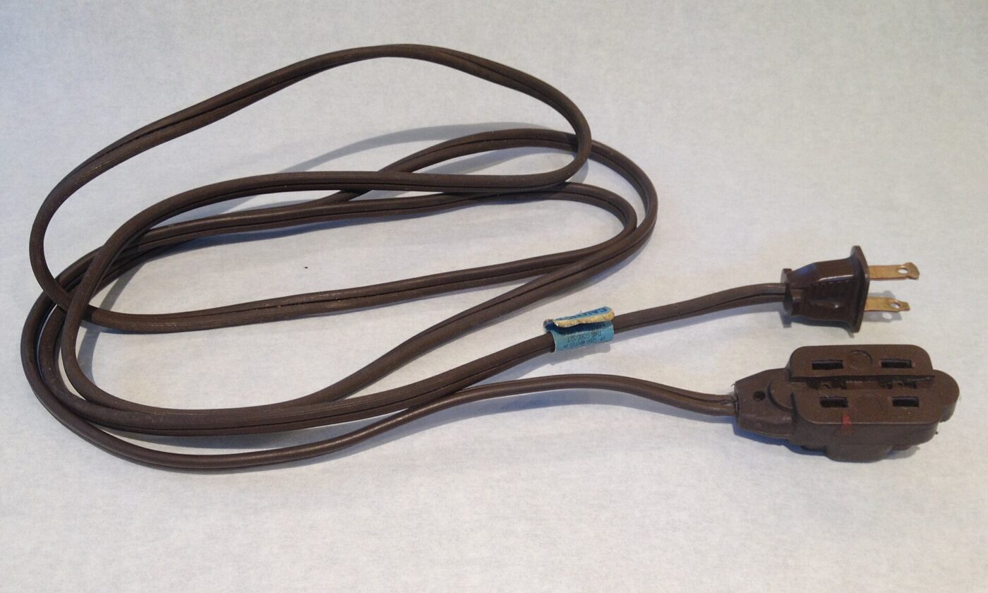 A coiled extension cord with a molded plug
