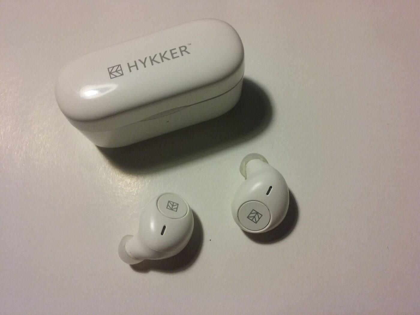 A pair of white wireless earbuds