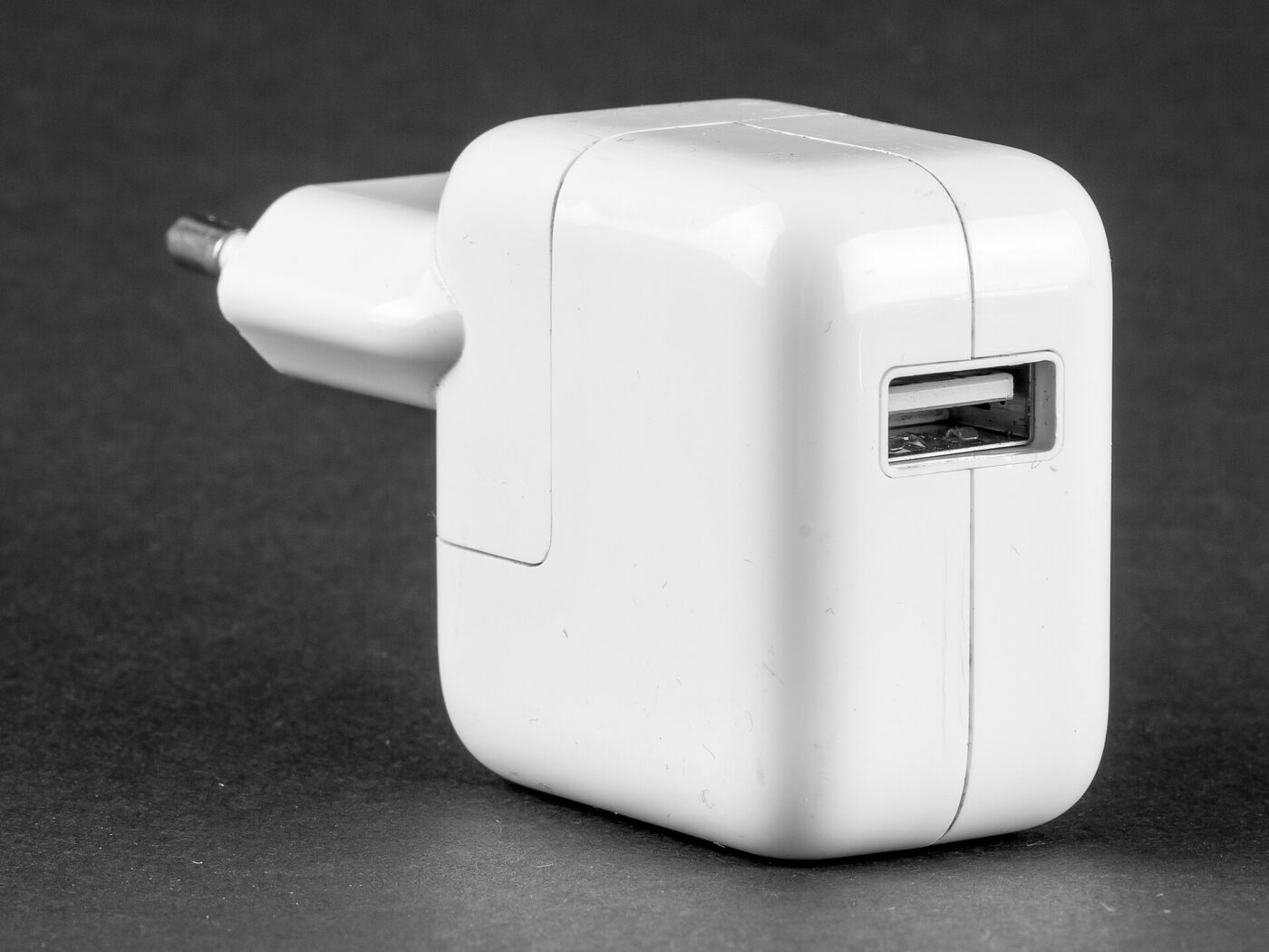 A white USB power adapter with a single USB port